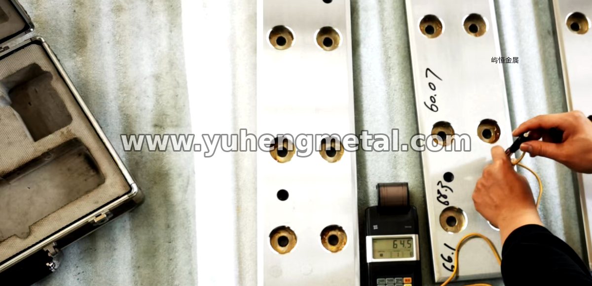 Leeb hardness tester checking a wear-resistant composite plate in the workshop